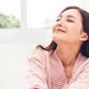 woman breathing clean air in her home having installed a RGF Guardian Air unit