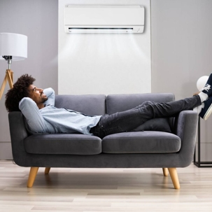 man breathing in clean air after purifying the air in his apartment