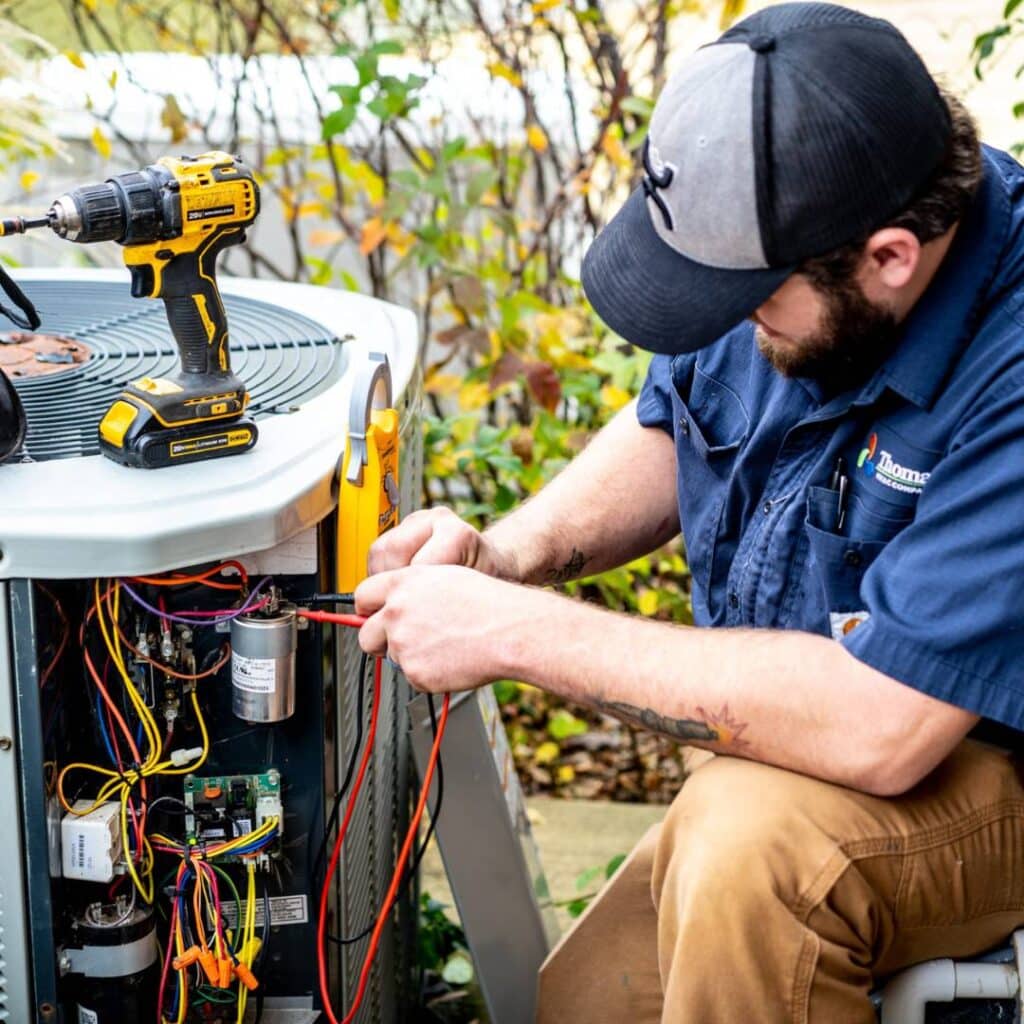 Technician repairing HVAC system