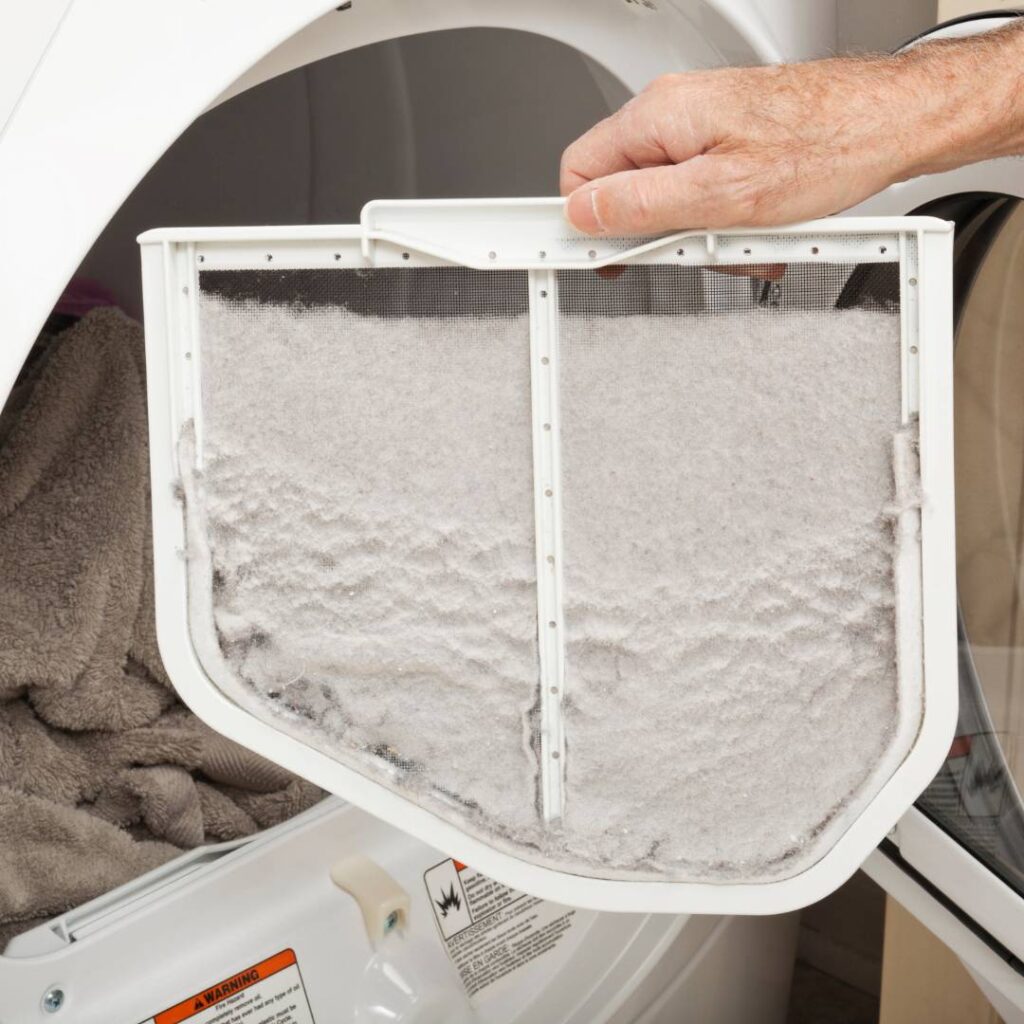 woman cleaning dryer vent
