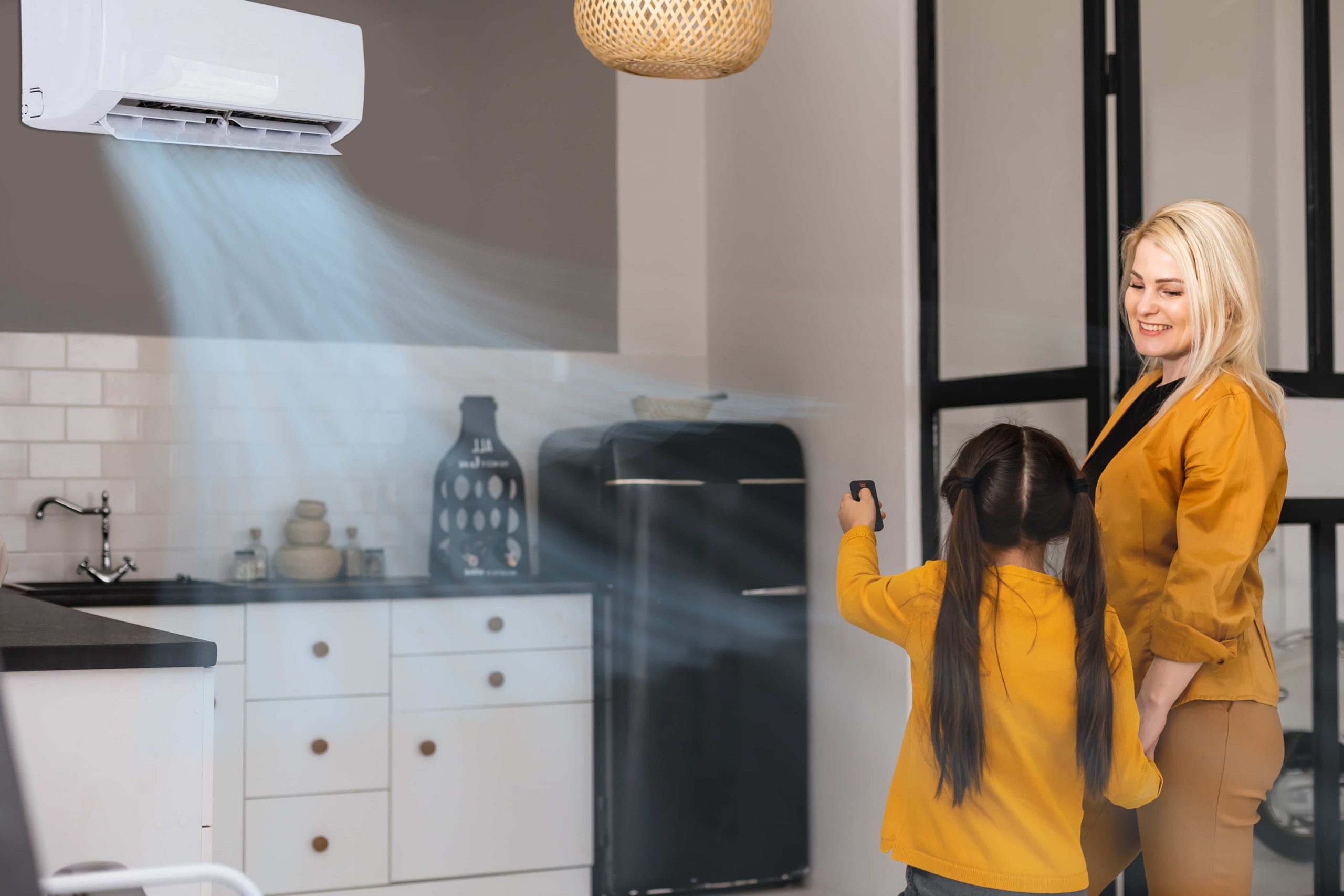 mom and daughter using air conditioner
