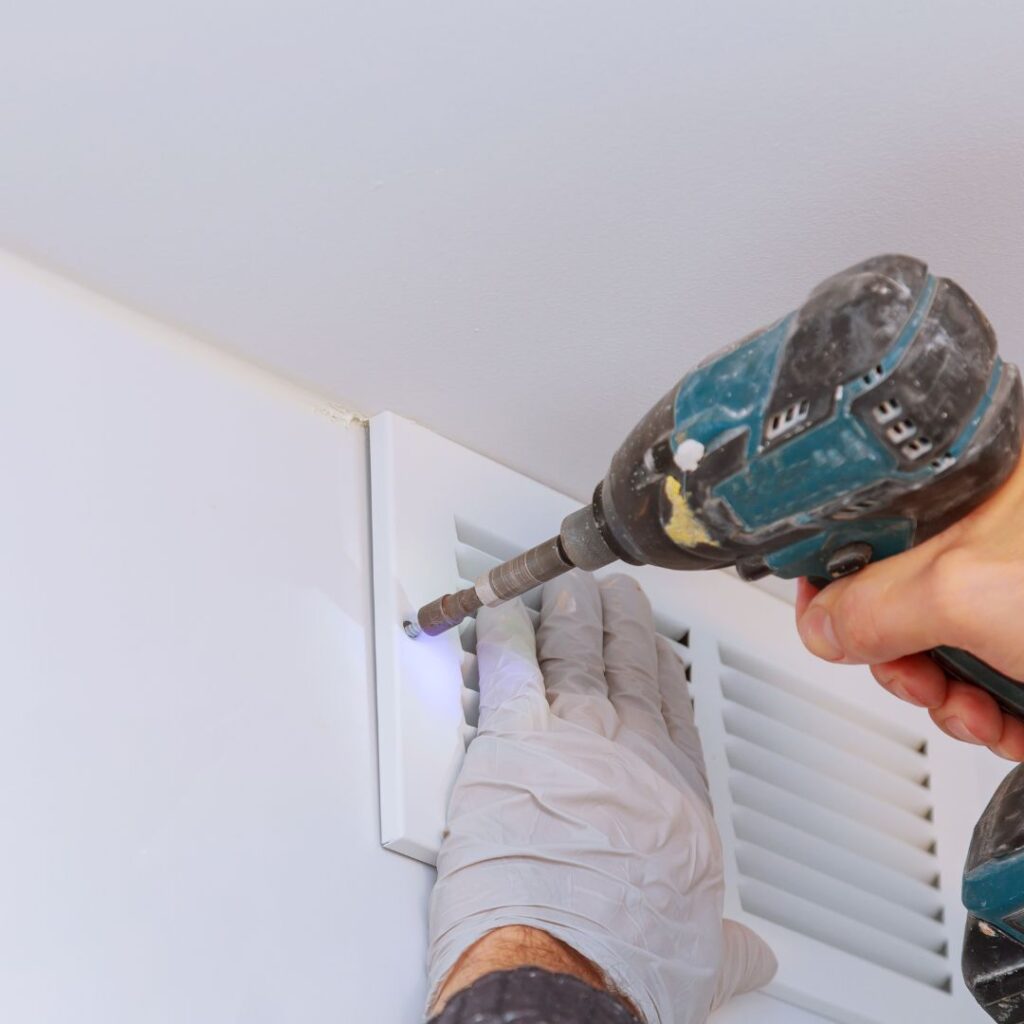 HVAC professional cleaning dirty air vents in alabama home