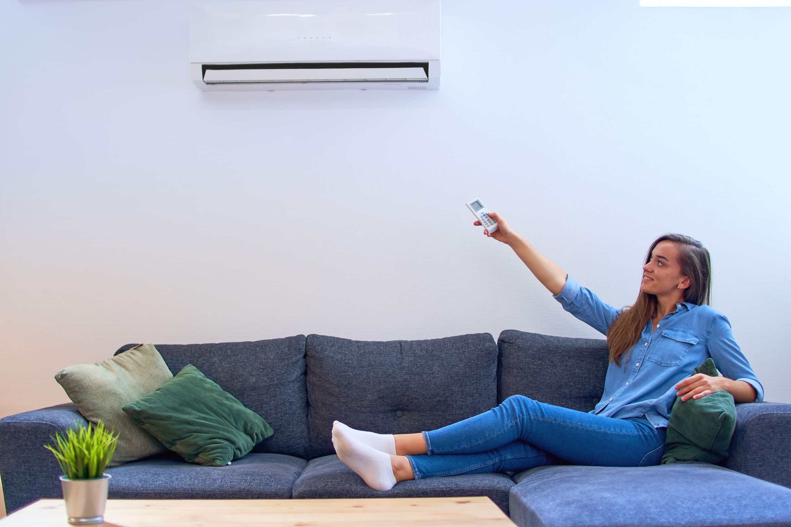 woman using a mini split ac unit