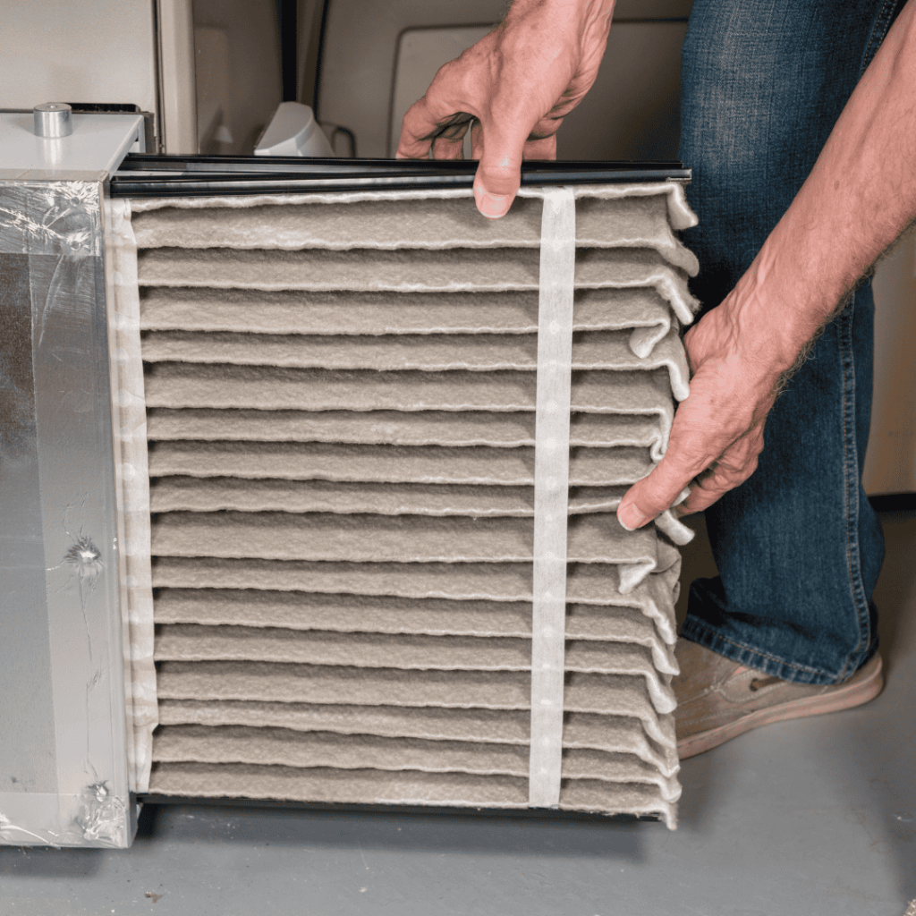hvac professional working on furnace during the winter