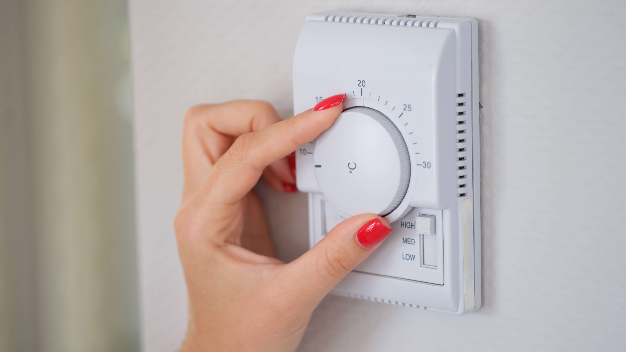 hand adjusting temperature gauge