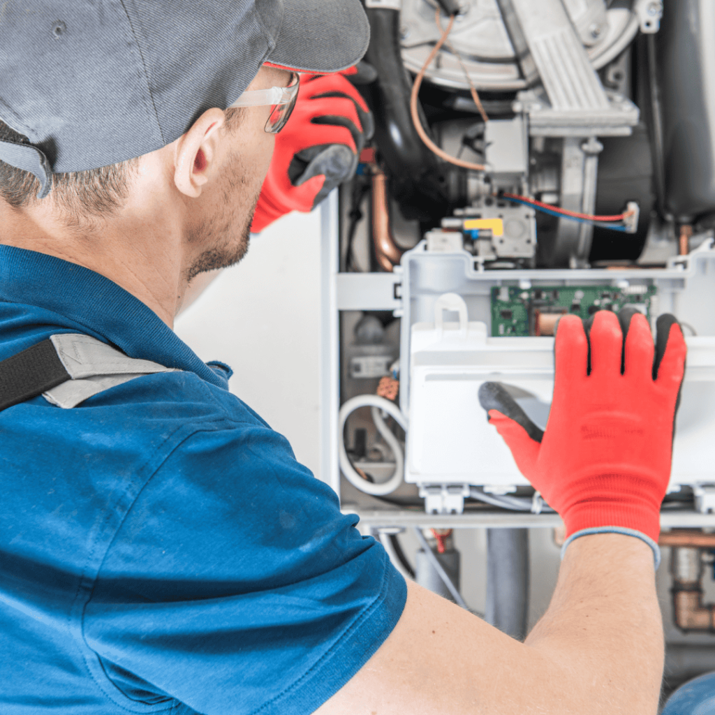 hvac professional working on furnace with carbon monoxide leak