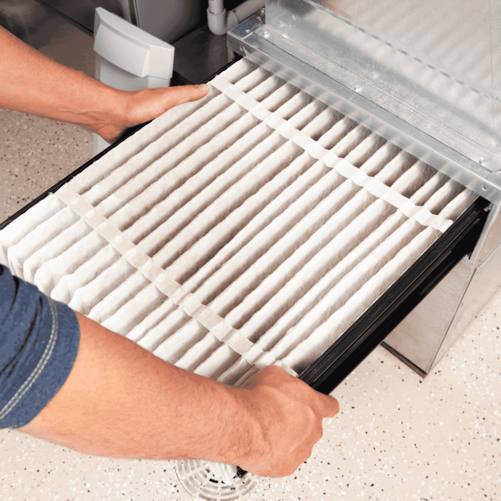thomas hvac employee replacing hvac filter with a new clean one